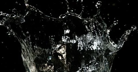 Water Exploding and Splashing against Black Background Stockfoto's
