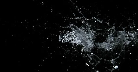 Water Exploding and Splashing against Black Background Stockfoto's