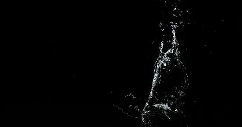 Water Exploding and Splashing against Black Background Stock Photos