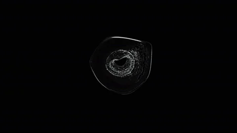 Water exploding in slow motion and spreading droplets on a black background Stock Footage 132654081