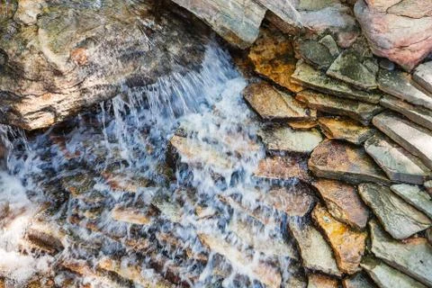 Water fall on dark decorative stone Stock Photos