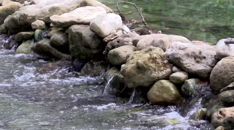 Water fall flowing though rocks in a river Video stock 53337845