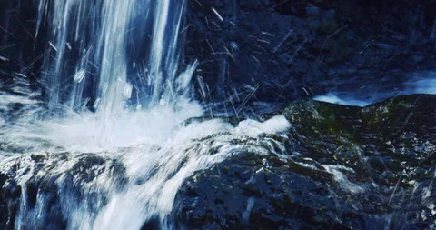 Water fall splashing over mossy volcanic rock in Hawaii Stock Footage 330755053