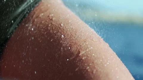 Water falling and dripping off of a leg to show off muscle. Wearing green Video stock 143790490