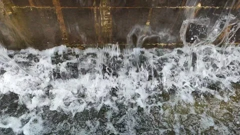 Water falling from artificial waterfall loud pouring sound video Stock Footage 246430334