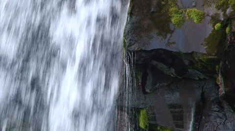 Water falling by black volcanic rocks Stock Footage 38020958
