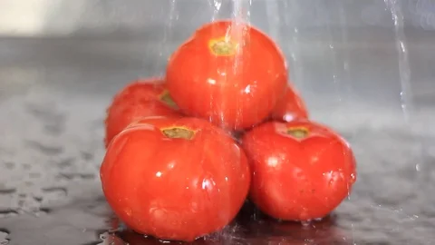 Water falling on bunch of tomatoes isolated Stock Footage 94120641