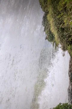 Water falling from the cliffs under Magnificent Huangguoshu Grand Waterfall i Stock Photos
