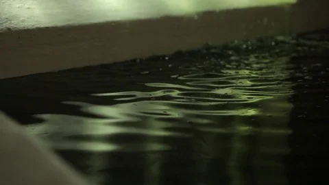 Water falling in a dark spa pool with light reflections Stock Footage 84220012
