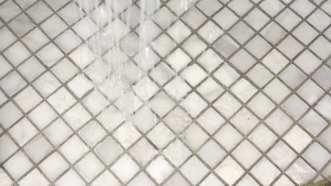 Water falling onto a diamond pattern mosaic of white marble tiles in a rela.. Stock Footage 335139335