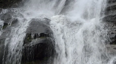 Water falling down cascading over rocks Stock Footage 52555719