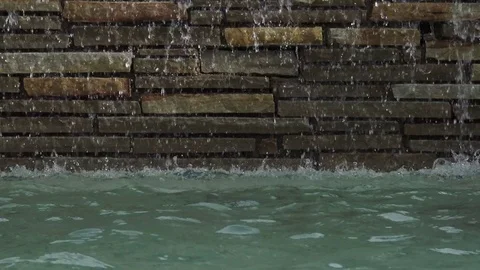Water falling down in front of stone work Video stock 76257038