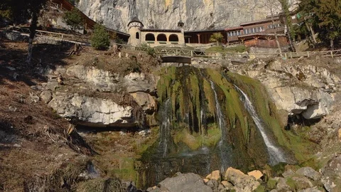 Water falling down the rocks under the old aches Stock Footage 123584737