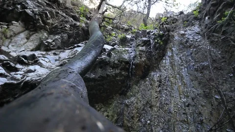 Water falling down rocky cliff Stock Footage 93573559