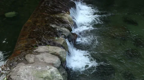 Water falling frow  small dike. Stock Footage 27372838