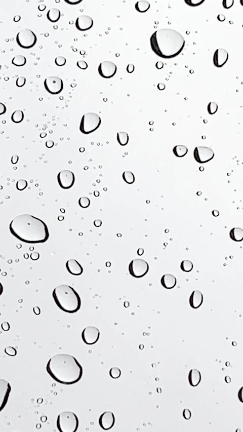 Water falling on a glass and creating moving water drops Stock Footage 192822940