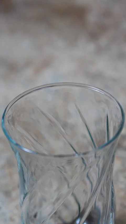 WATER FALLING INTO A GLASS CLOSE VERTICAL 4K C1681 Stock Footage 335306665