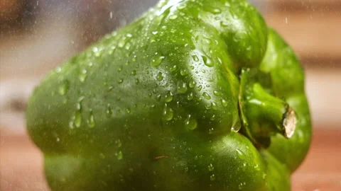 Water falling on green bell pepper in slow motion Stock Footage 152905253