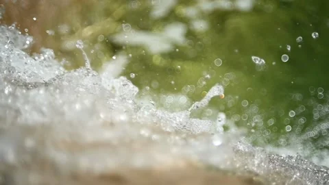 Water falling into a green pool in the mountains (slow motion, bokeh) Stock Footage 219635299