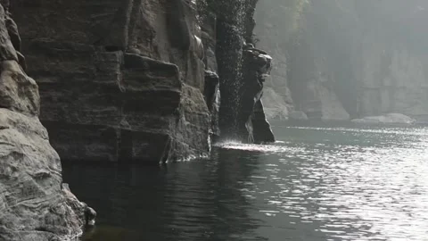 Water falling from mountain on a river 库存影片 273030214