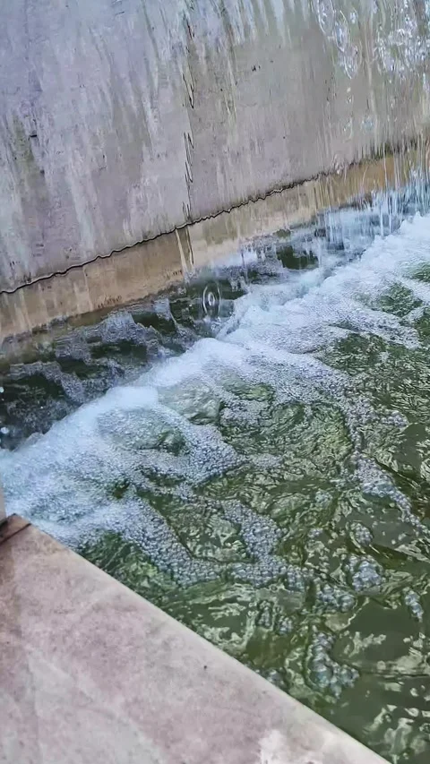 Water Falling Over Concrete Ledge Into Bubbling Fountain Pool Stock Footage 339079974