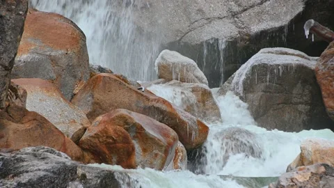 Water falling over orange rocks cascades Stock Footage 150402918