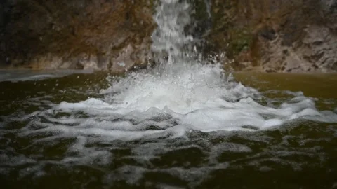 Water is falling into a pool in the mountains (slow motion) 스톡 동영상 212754517