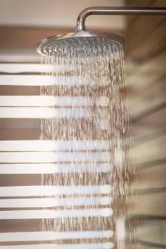 Water falling from rain shower head Stock Photos