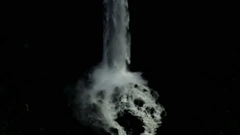 Water falling on the rocks below a waterfall with a black background Stock Footage 155302693