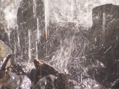 Water falling onto rocks Stock Footage 27344728