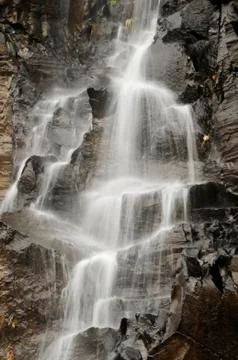 Water falling on rocks vertical Stock Photos