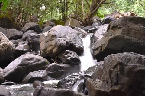 Water falling through the big rocks Stock Photos