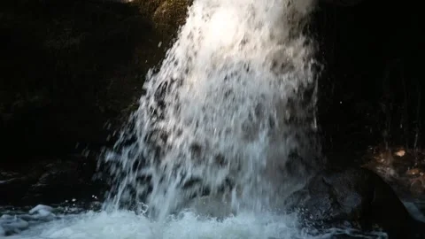 Water falling through sunlight into a pool (slow motion) Stock Footage 219395759