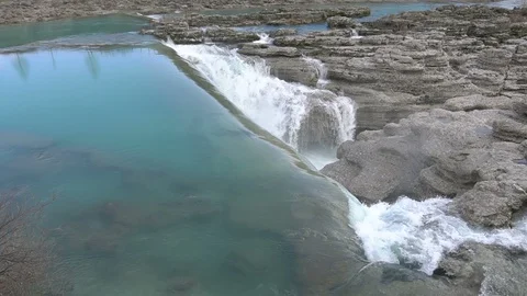 Water falls down a waterfall. Big amount of water falling over a rocky edge. Stock Footage 91515658