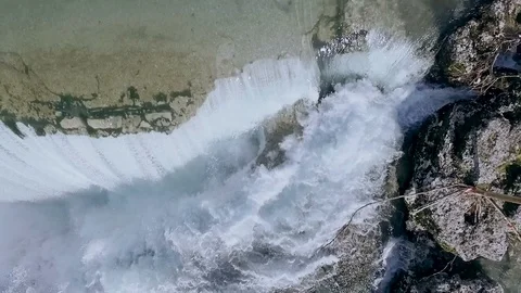 Water falls down a waterfall. Big amount of water falling over a rocky edge. Stock Footage 91517359