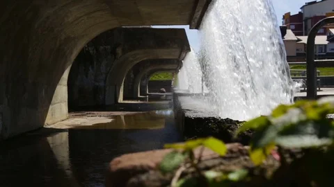 The water falls from the height, clears the air in the city.  Spring, the Genera Stock Footage 85283029
