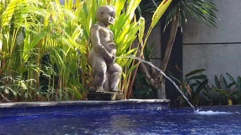 Water falls into the pool through the figure of a pissing boy. Stock Footage 111893337