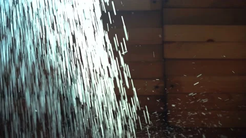 Water falls in thin streams. The shower falls close up, backlit by sunlight on a Stock Footage 135002897