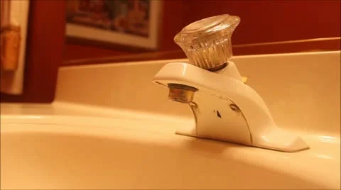WATER FAUCET DRIP SIDE VIEW Stock Footage 12364756