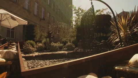 Water Feature in front of a bar on a hot sunny day - slider shot Stock Footage 112722537