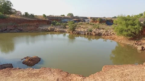 Water Filled Borrow Pit Landscape In Semi Arid Africa Kano Nigeria 動画素材 324859482