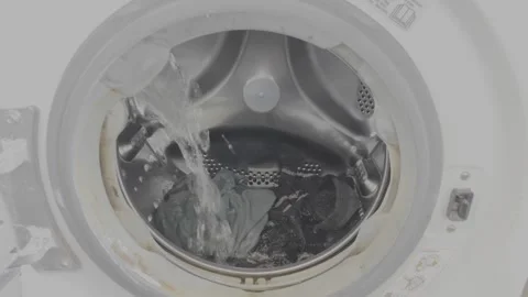 Water Filling Inside Front Load Washing Machine Drum with Laundry Stock Footage 334851395