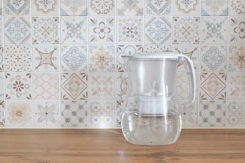 Water filter pitcher on kitchen counter with patterned tiles Photos
