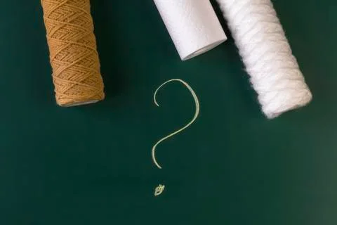 A water filter whose cartridge needs to be replaced. Question mark. Close-up. Stock Photos