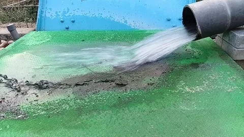 Water Filtered Through Green Mesh to Remove Algae Before Main Filters Stock Footage 328049353