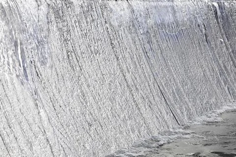 Water in flow. Abstract background - lines and bands blurred by water motion. Stock Photos
