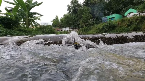 Water Flow and Ripples on Code River, Yogyakarta Video stock 320613026