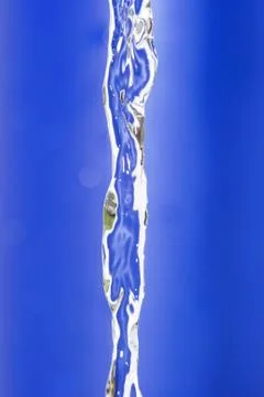 Water flow on blue background Stock Photos