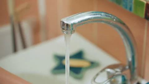 Water flow control. Teacher tests pressure and temperature carefully. Precise Stock Footage 345524033