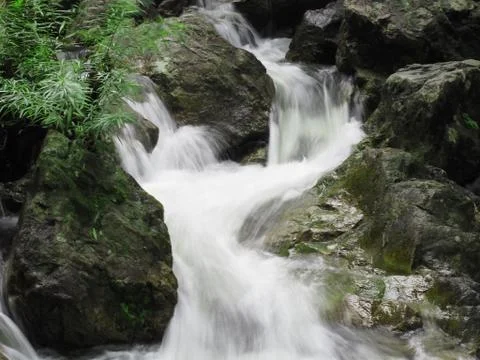 Water flow down between rock Stock Photos